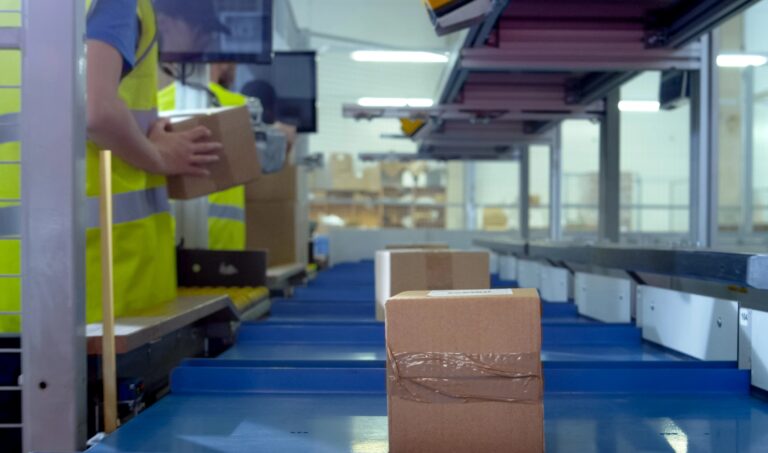 Worker Puts Parcel From Moving Belt Conveyor at Post Sorting Office. Box POV