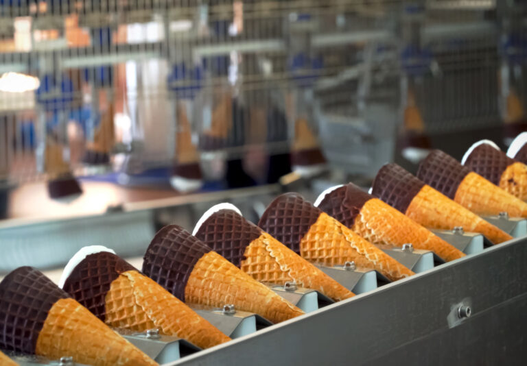 Ice cream cones on conveyor. Ice cream factory