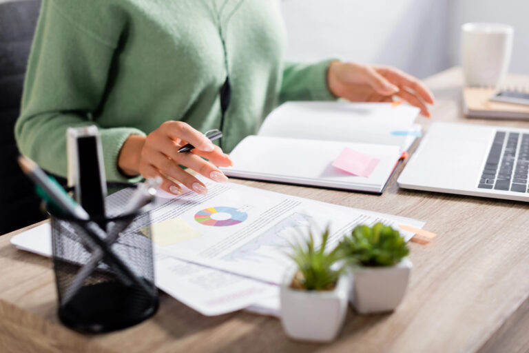 Professional reviewing recruiting performance reports and workforce metrics to calculate RPO ROI and hiring efficiency.