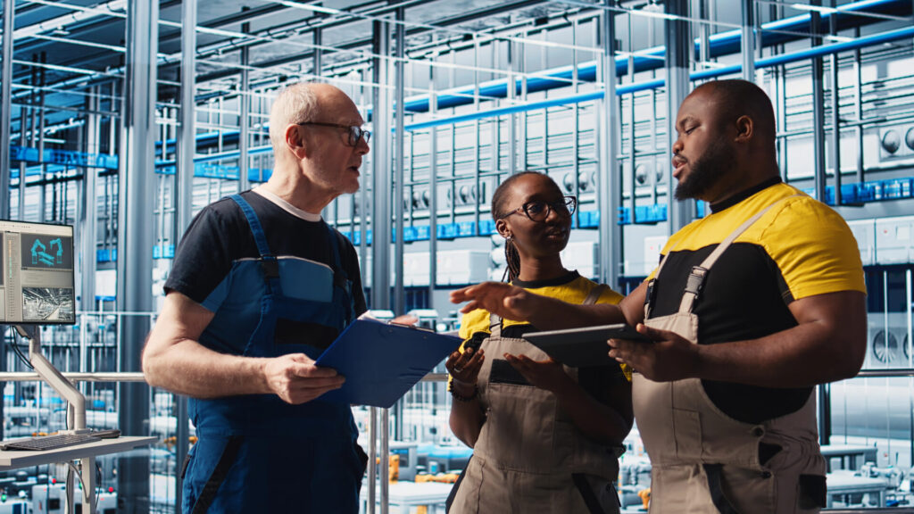 Manufacturing team discussing operations to reduce operational friction and improve productivity