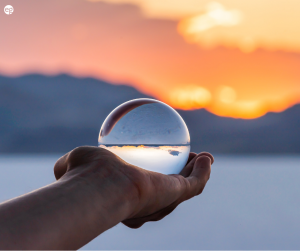 Transparent glass orb with a sunset in the background