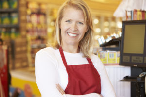 Retail worker in red apron